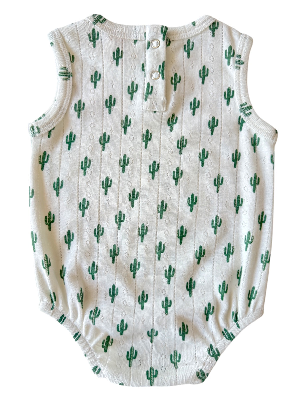 White sleeveless onesie with a cactus pattern and back snap buttons.