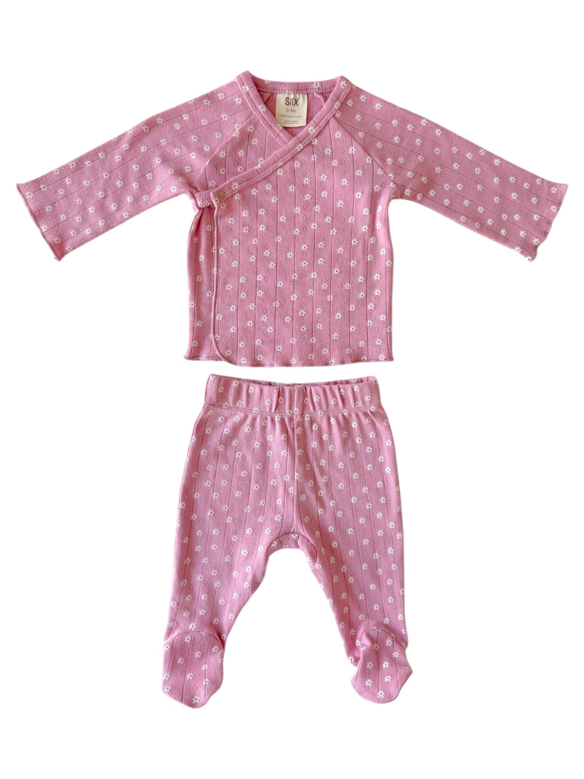 Pink baby outfit featuring a long-sleeve top with a wrap design and matching pants, both adorned with small white flowers.
