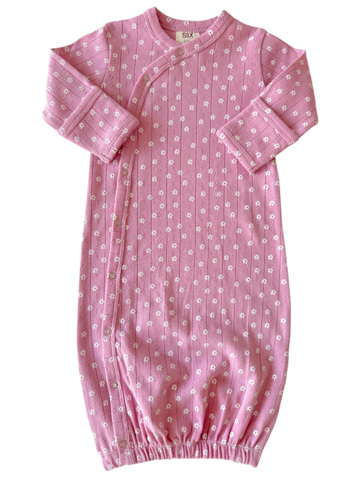 Pink baby gown with white floral print, features snap closures and elastic at the bottom for comfort.