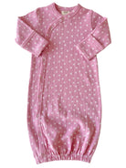 Pink baby gown with white floral print, features snap closures and elastic at the bottom for comfort.