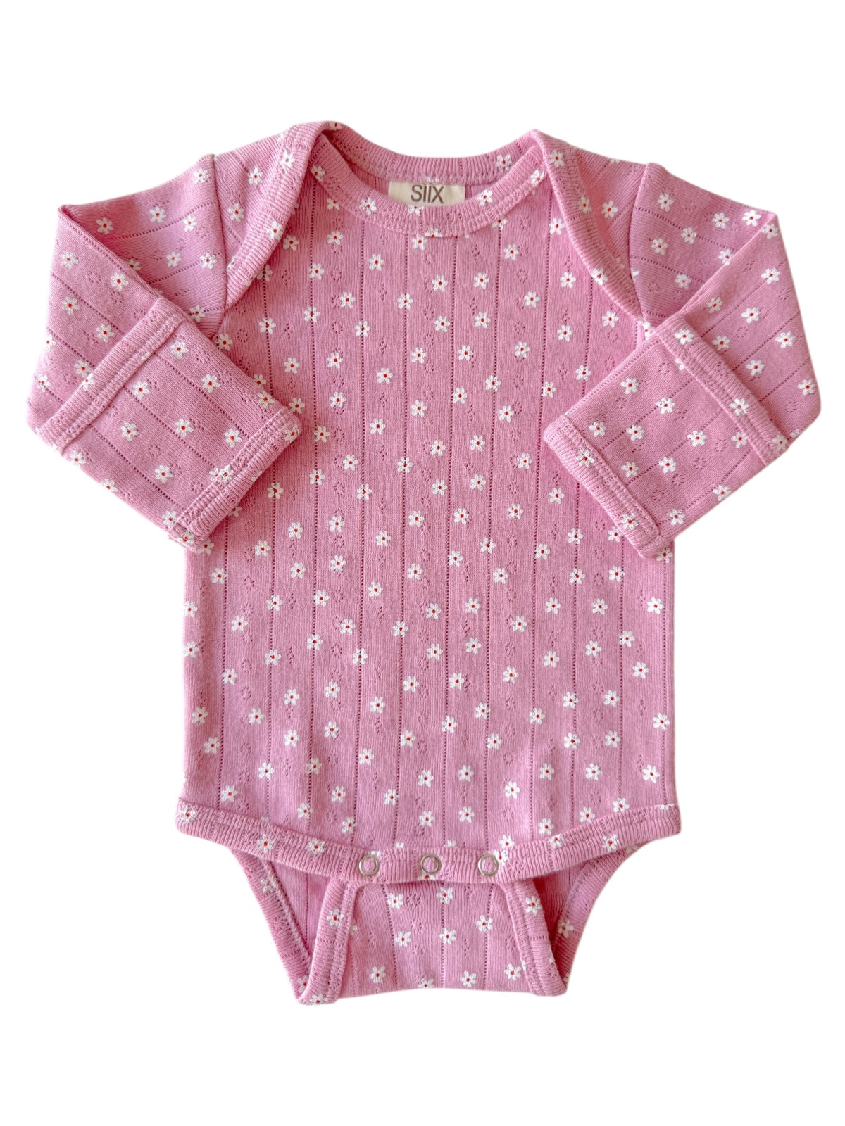 Pink baby bodysuit with floral pattern and long sleeves, featuring snap closures at the bottom.