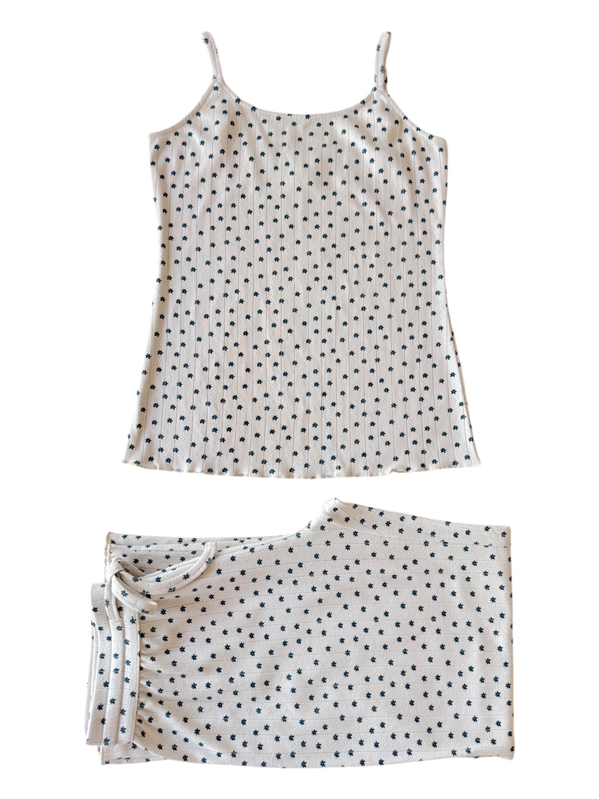 White sleep set featuring a tank top and shorts, both adorned with small dark star patterns.