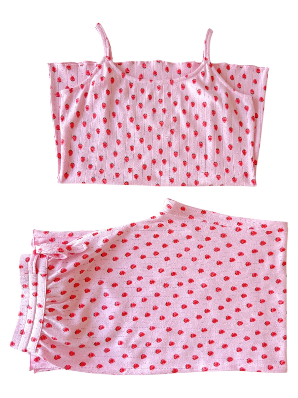 Pink crop top and matching skirt with red polka dots on a white background.
