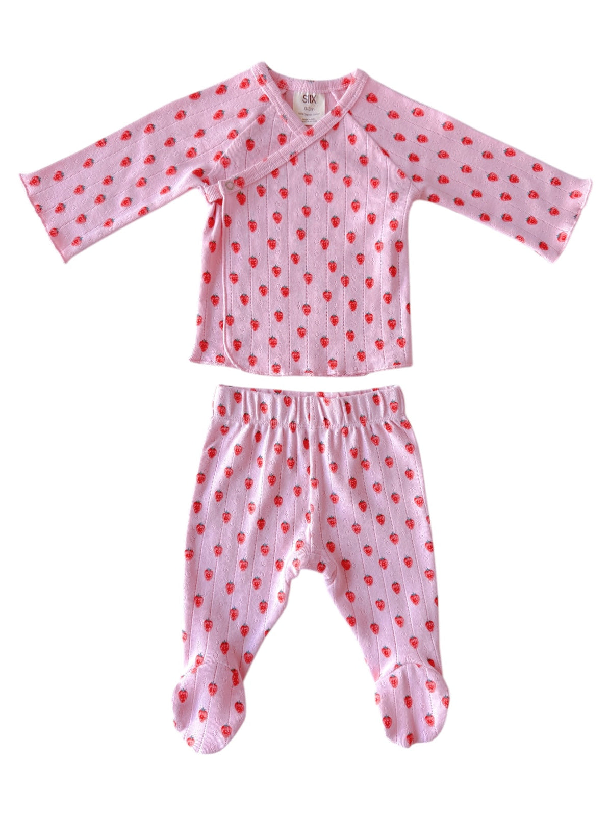 Pink children's pajama set features long sleeves and patterned with small red hearts.