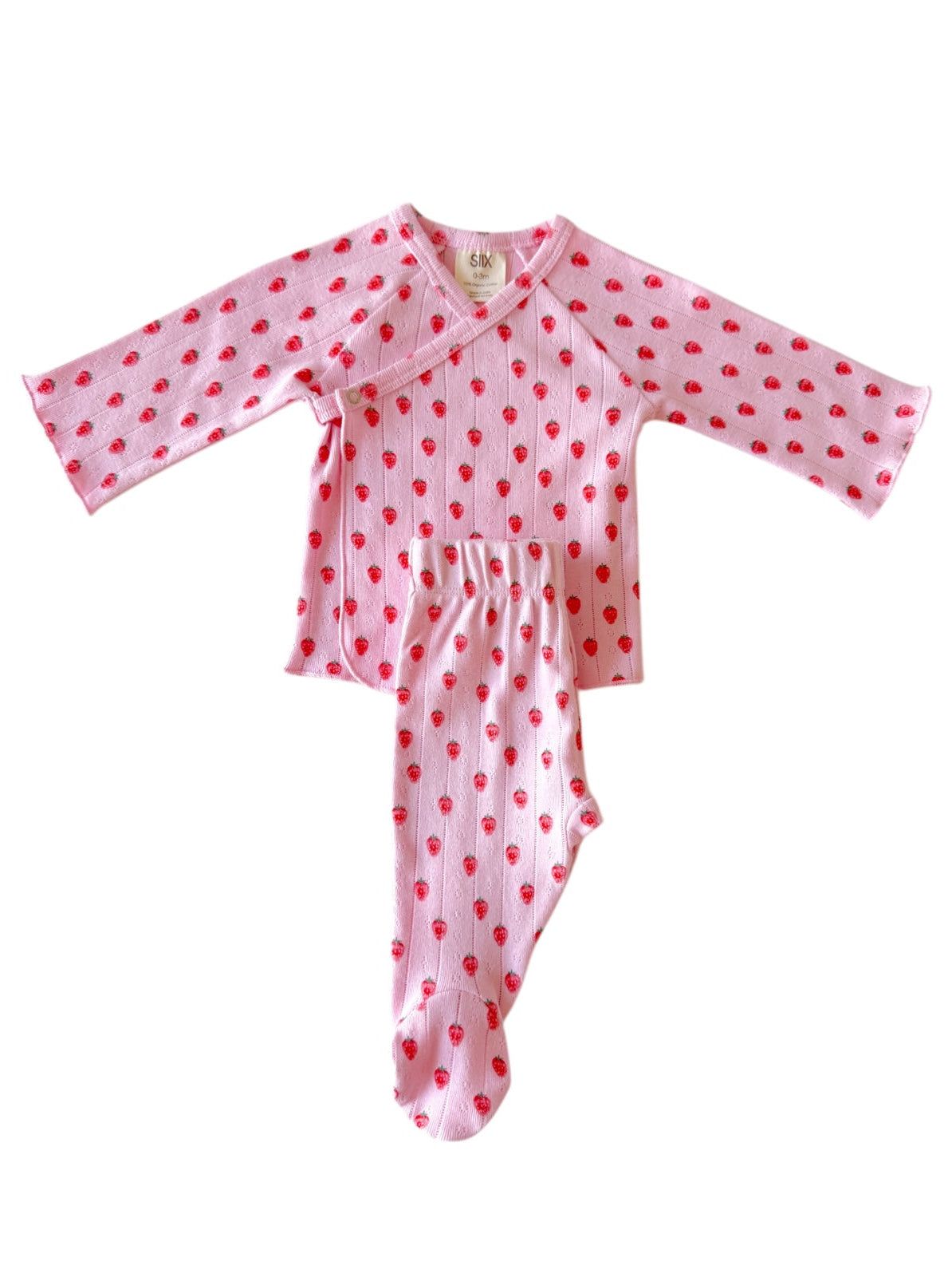 Pink baby outfit with long sleeves and strawberry print, featuring a wrap top and footed pants.