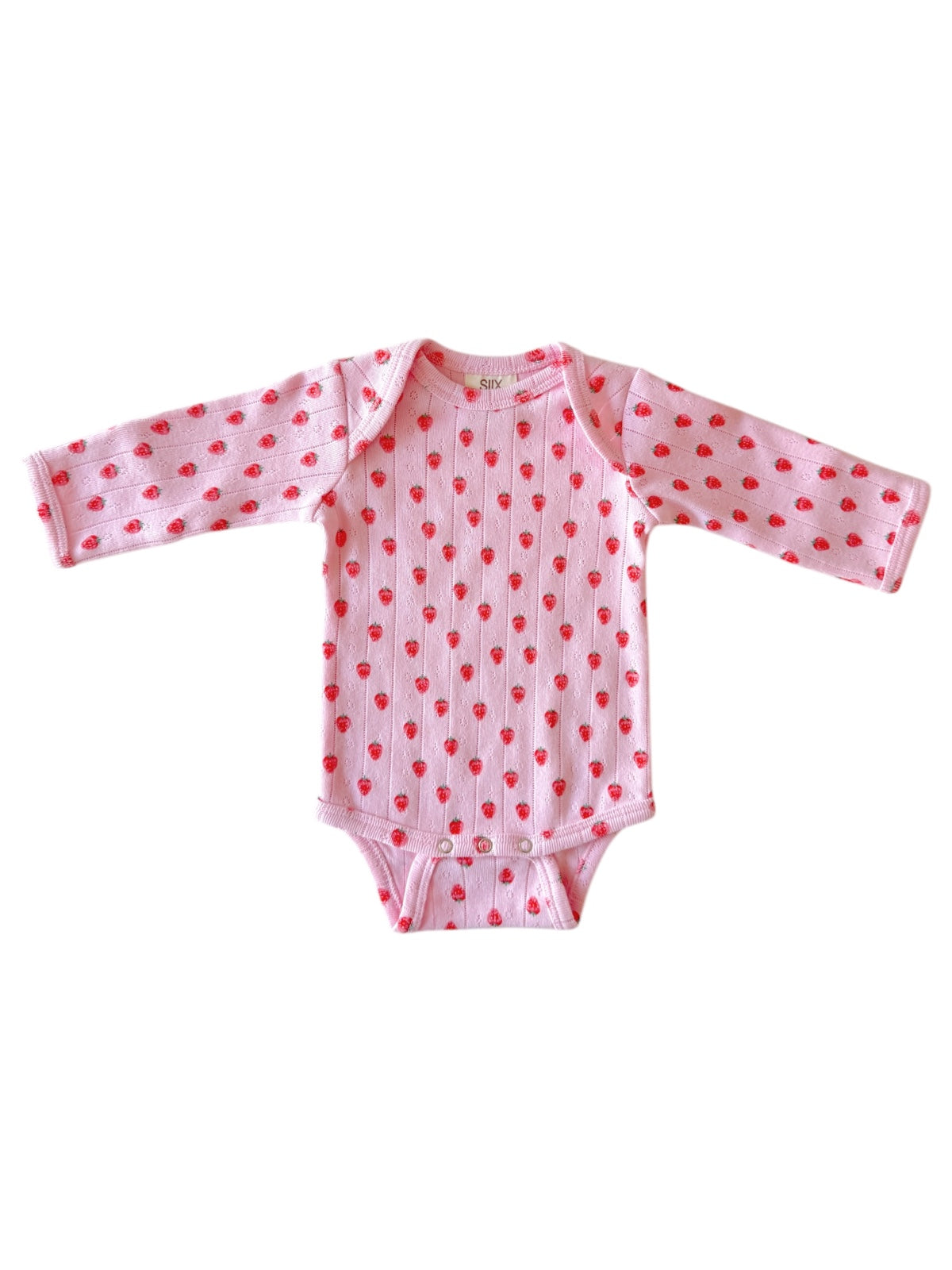 Pink baby onesie with long sleeves, featuring a pattern of small red hearts. Perfect for infants.