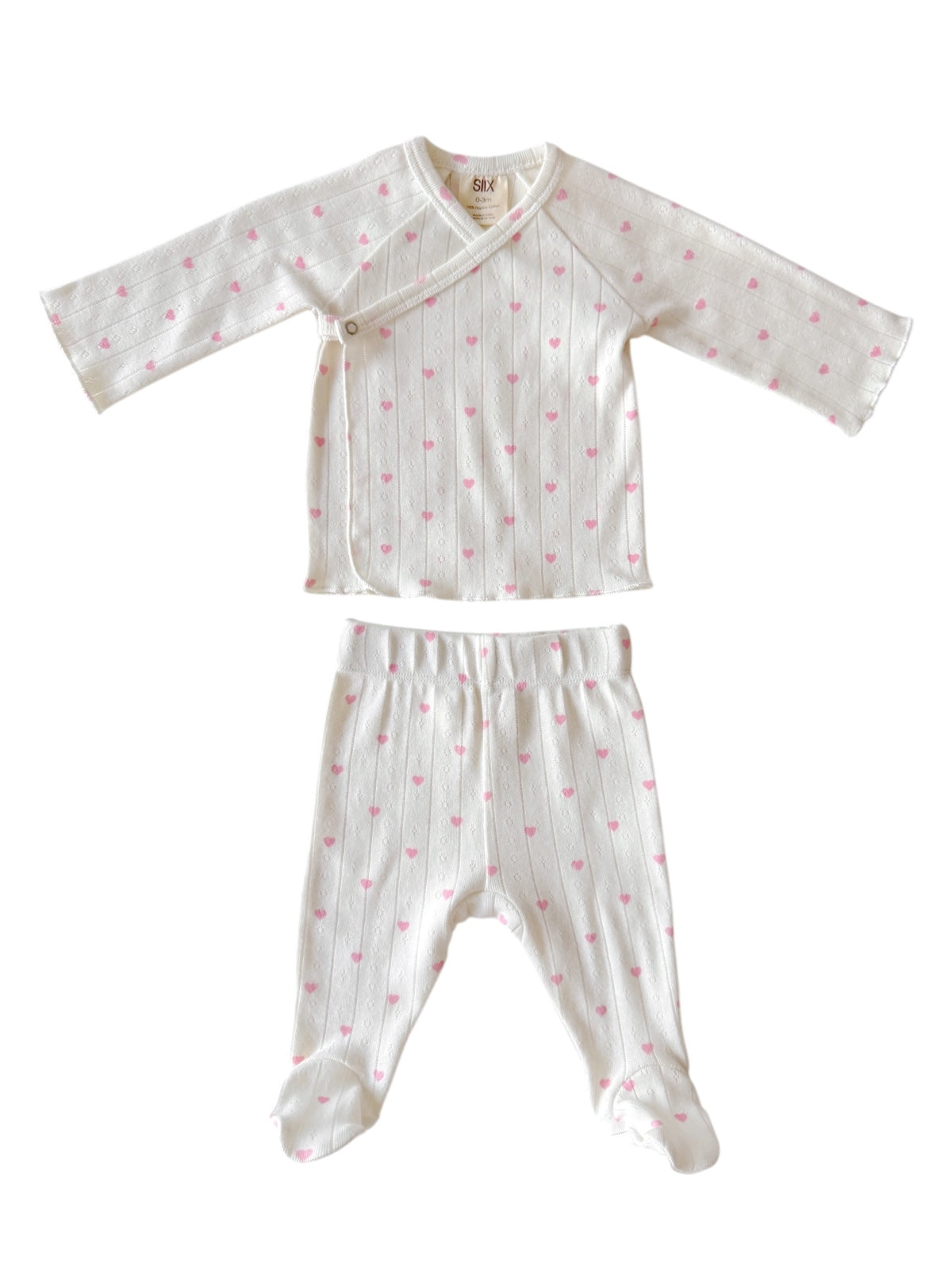 White baby outfit with pink hearts, includes a long-sleeve wrap top and matching pants. Perfect for infants.