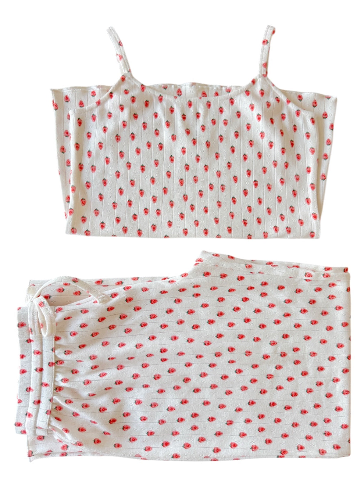 White pajama set with red floral pattern, featuring a cami top and matching drawstring pants.