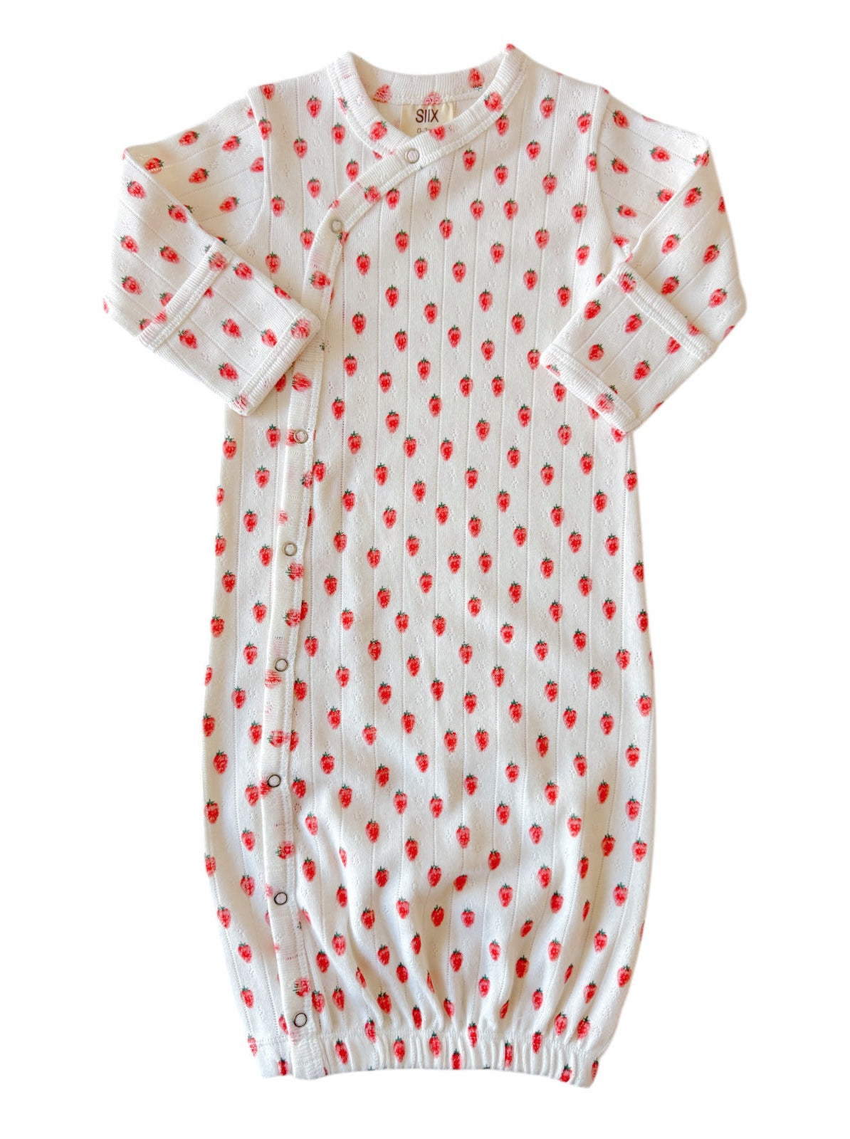 White baby gown with red strawberry pattern, featuring long sleeves and snap buttons along the side.