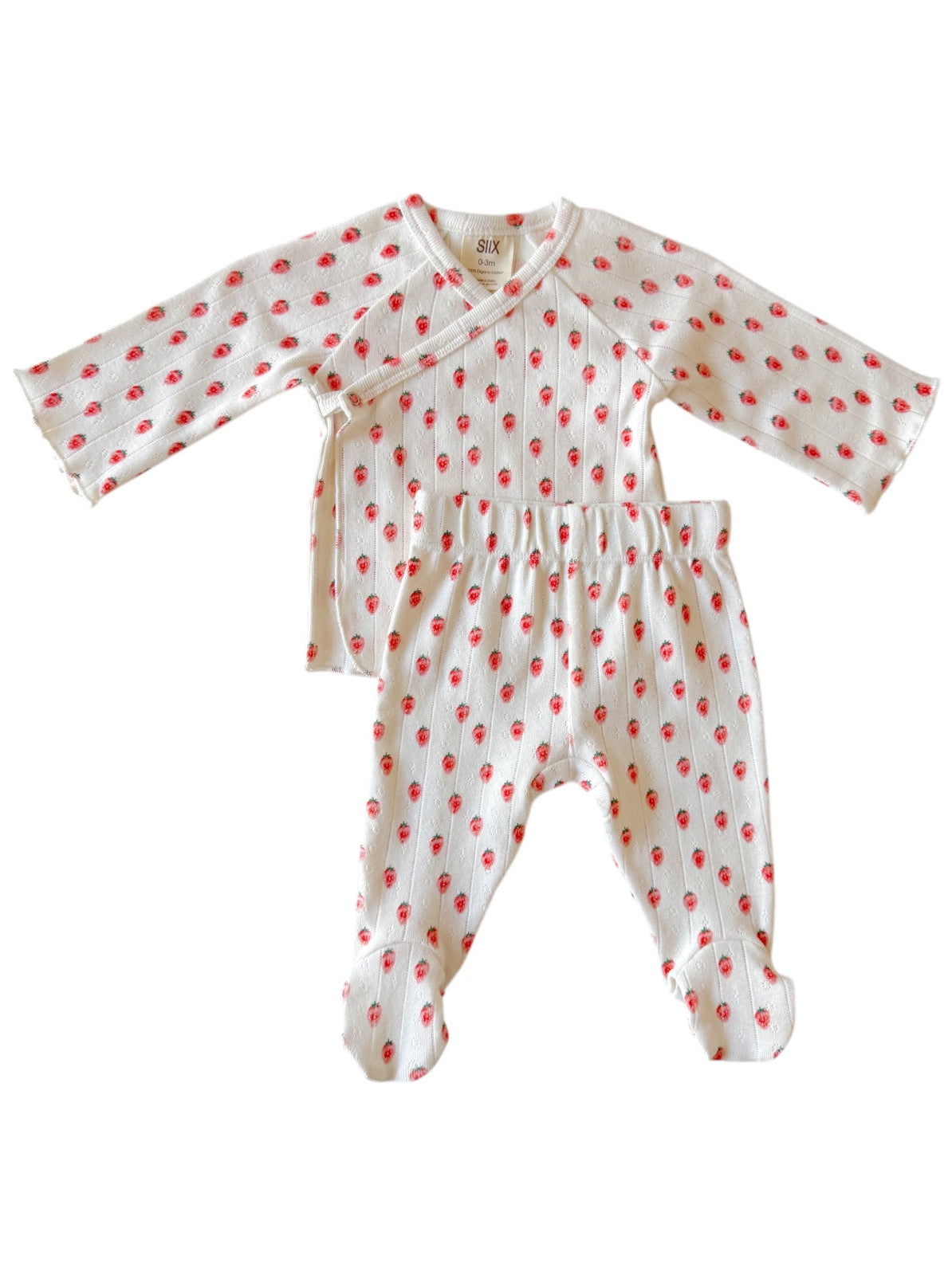 Baby outfit with long-sleeve top and footed pants, featuring a white background and red floral print.
