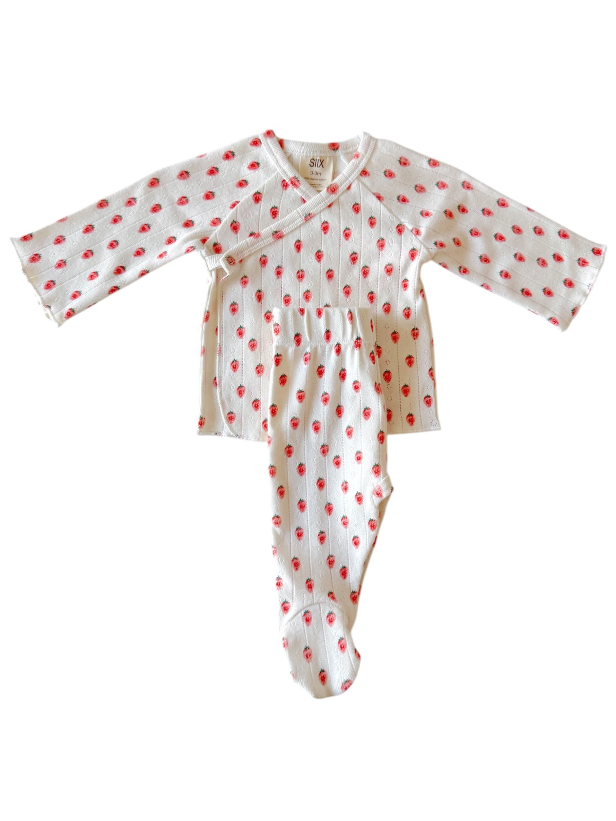 White infant outfit with long sleeves and red strawberry pattern, featuring a wrap top and footed pants.