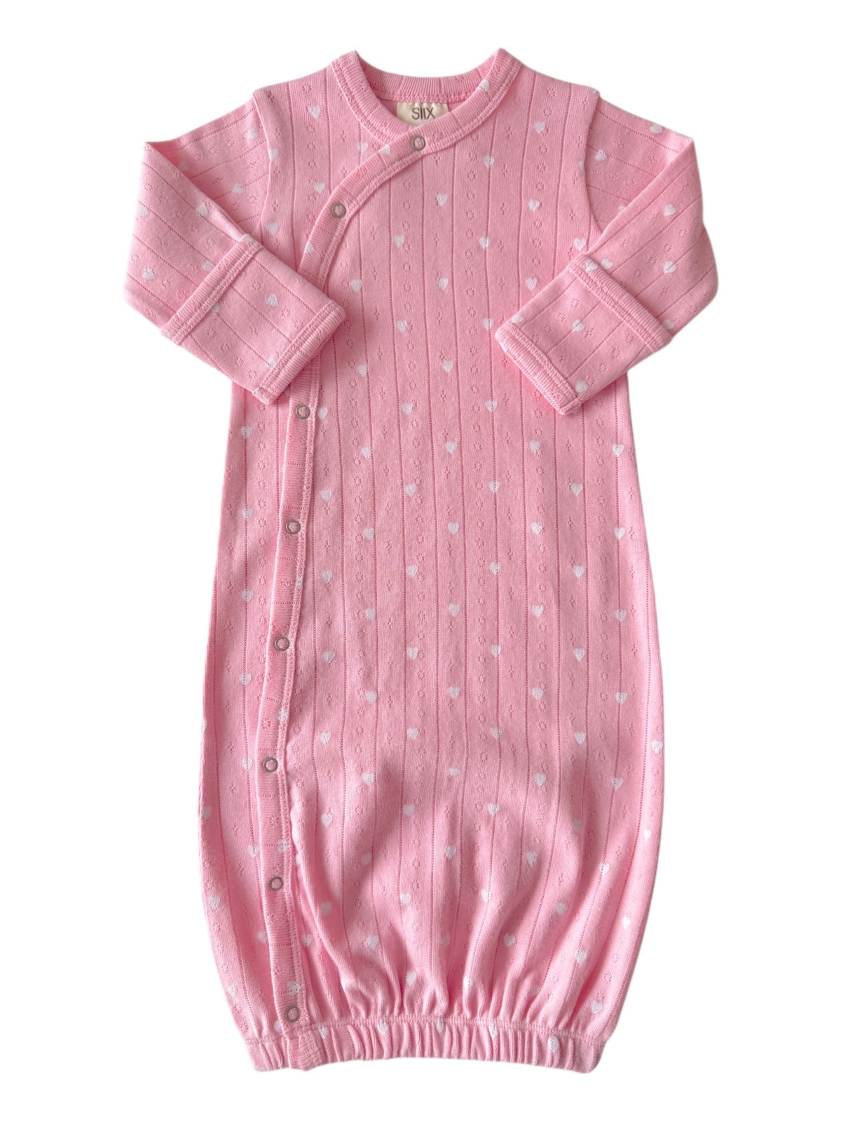 Pink baby sleep gown with white heart patterns, featuring long sleeves and button closures along the side.