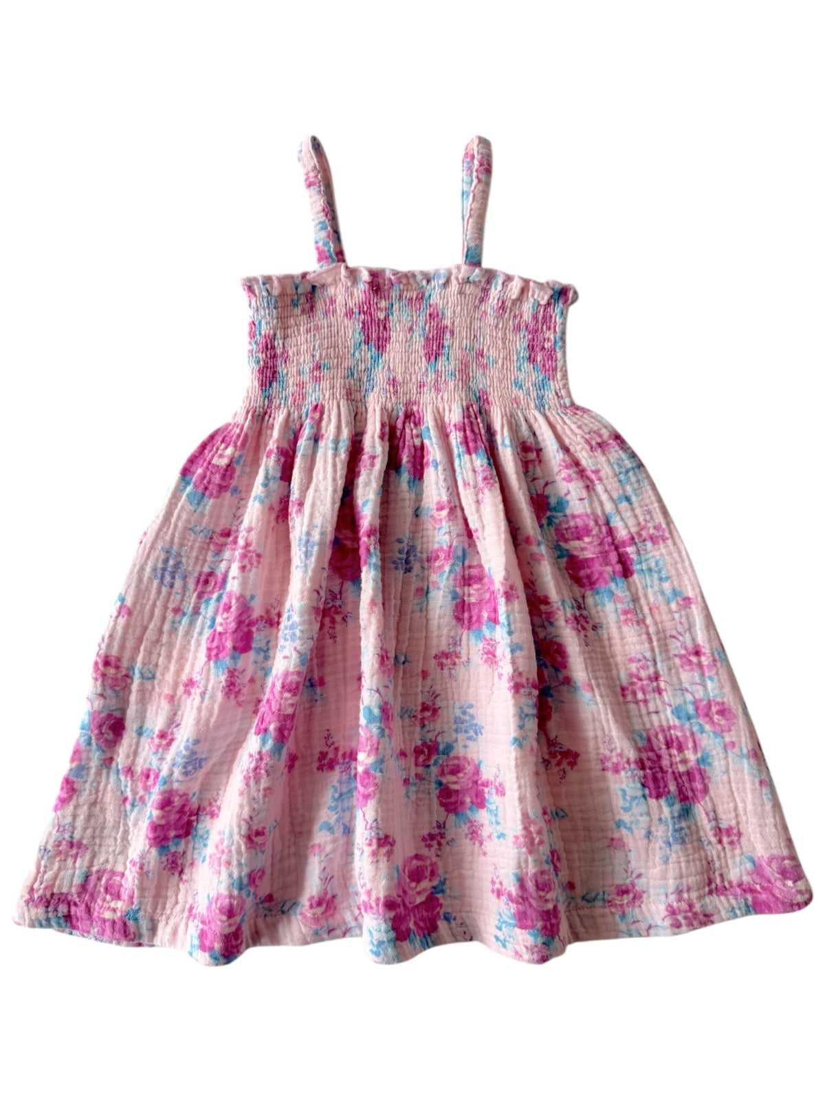 Floral pattern dress in pink with blue accents, featuring adjustable straps and a smocked bodice.