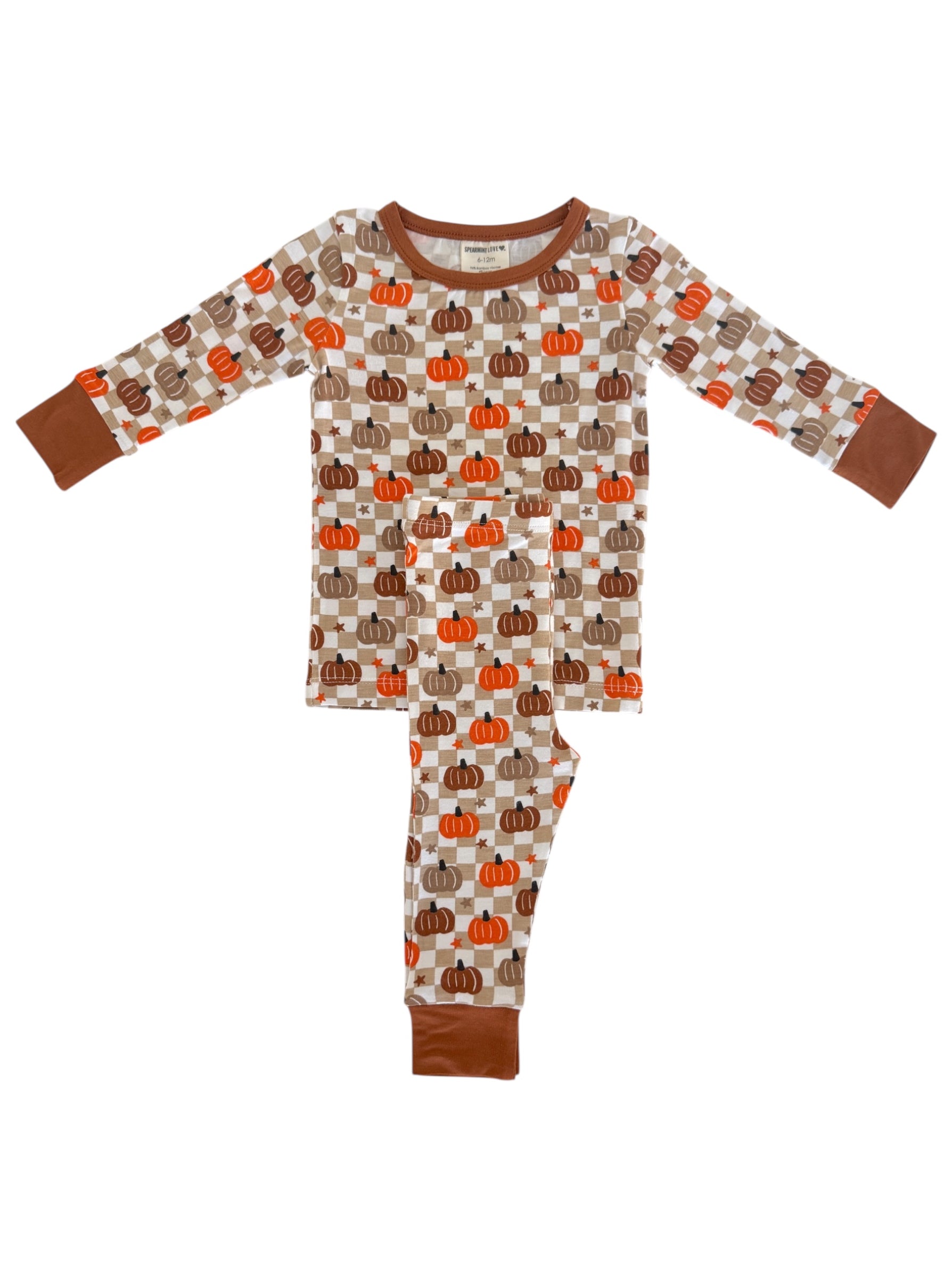 Pumpkin-patterned pajamas for kids in cream, orange, and brown colors with long sleeves and pants.