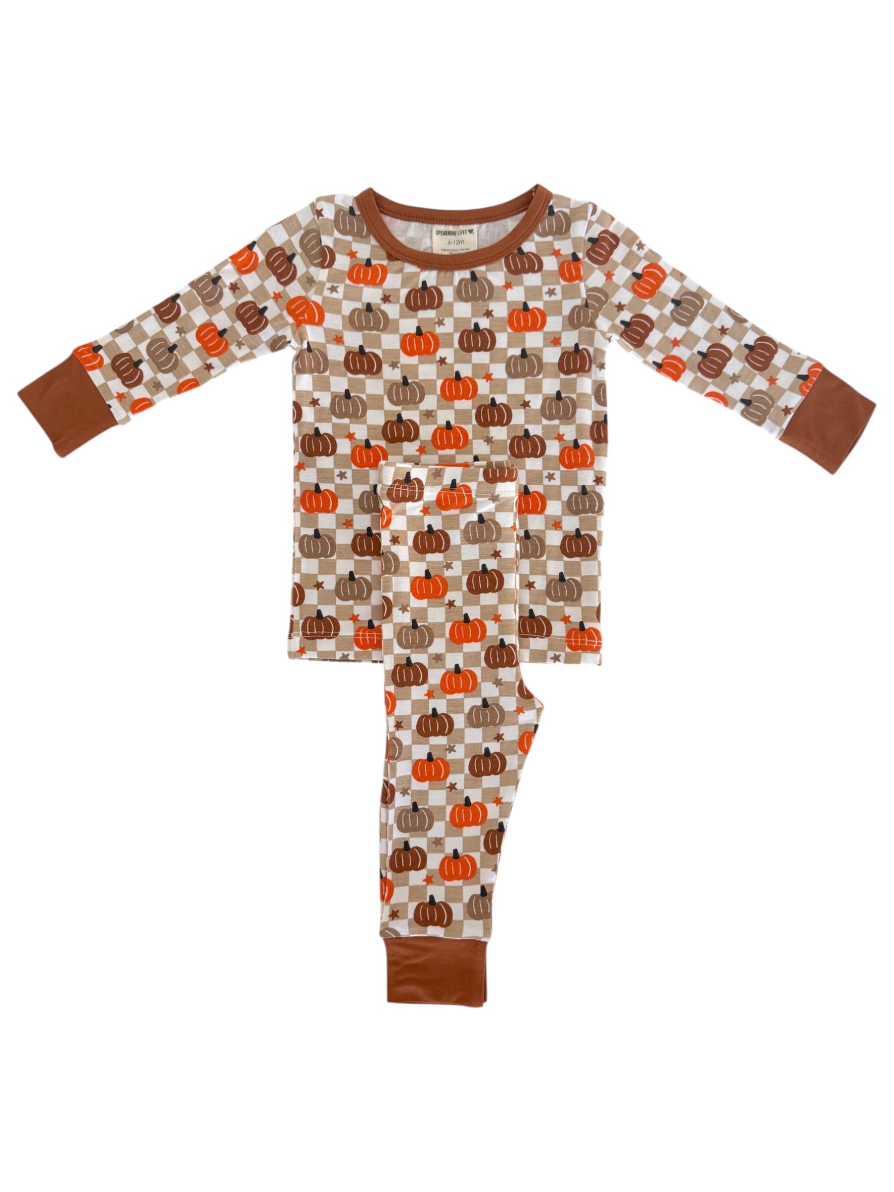 Pumpkin-patterned pajamas for kids in cream, orange, and brown colors with long sleeves and pants.