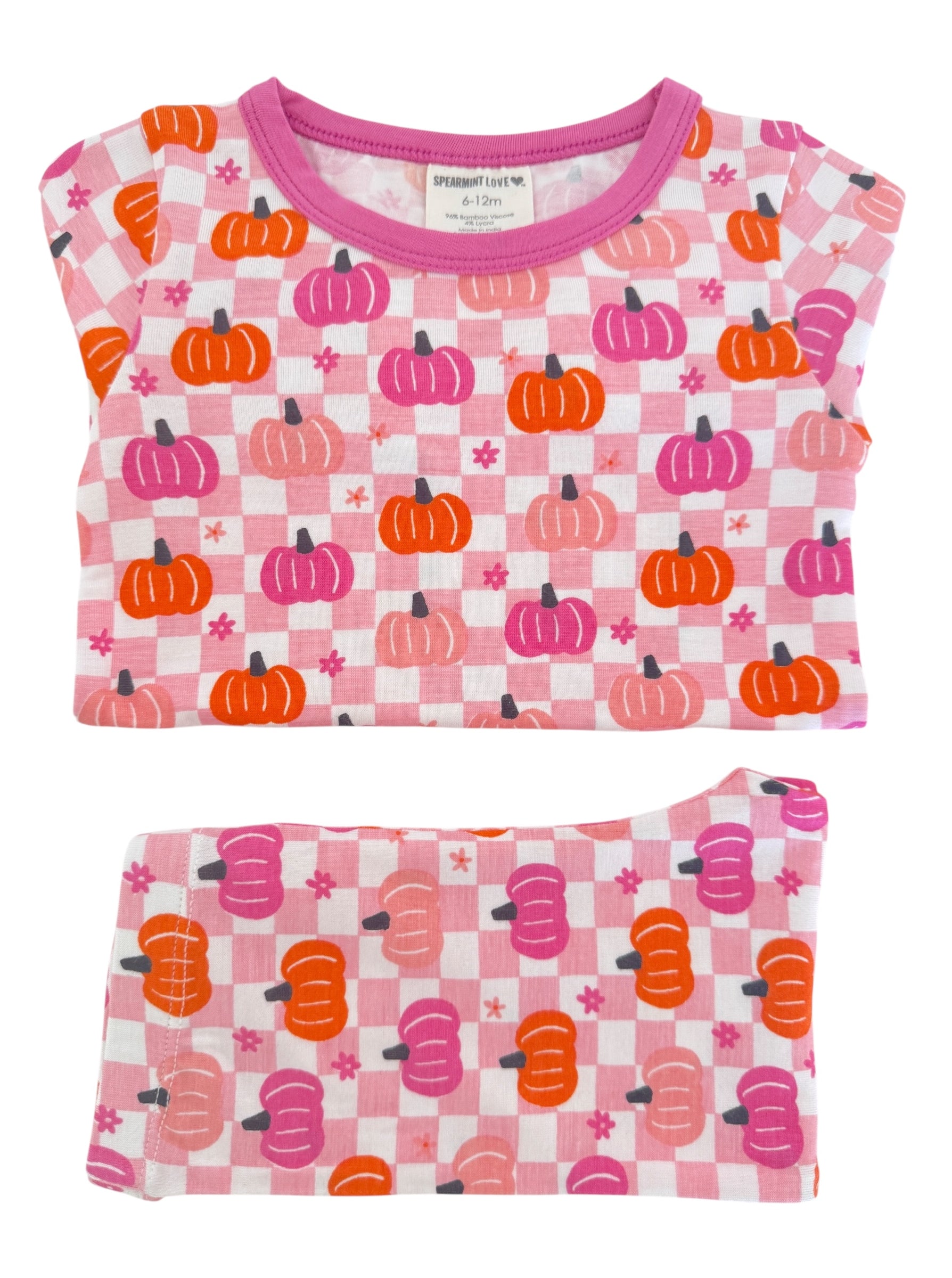 Pink pajama set featuring orange and purple pumpkins on a checkered pattern, size 6-12 months.