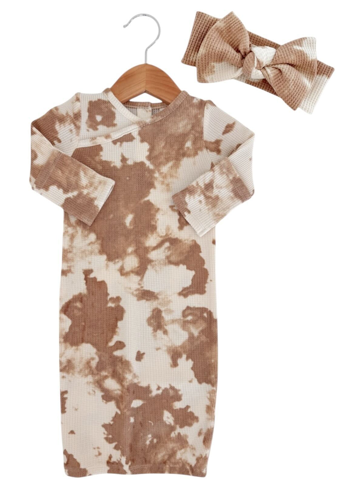 Brown and cream tie-dye dress and matching headband on a hanger. Perfect for casual, stylish outfits.