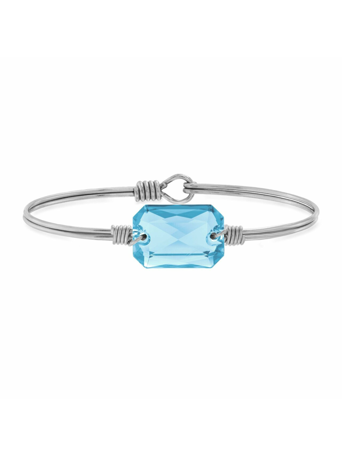 Silver bracelet featuring a large, faceted blue gemstone, elegantly designed on a white background.