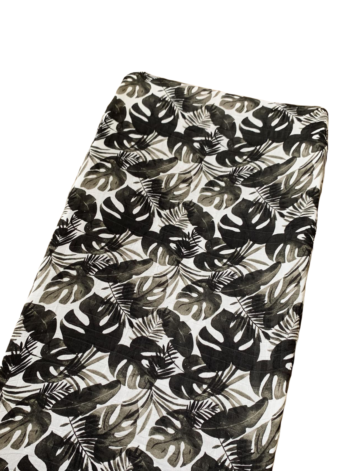 Black and white fabric featuring a tropical leaf pattern on a light background.