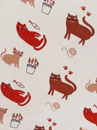 Pattern of various cartoon cats, fish, plants, and yarn on a light background.
