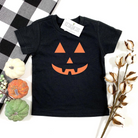 Black toddler t-shirt featuring an orange jack-o'-lantern design, surrounded by decorative pumpkins and cotton stems.