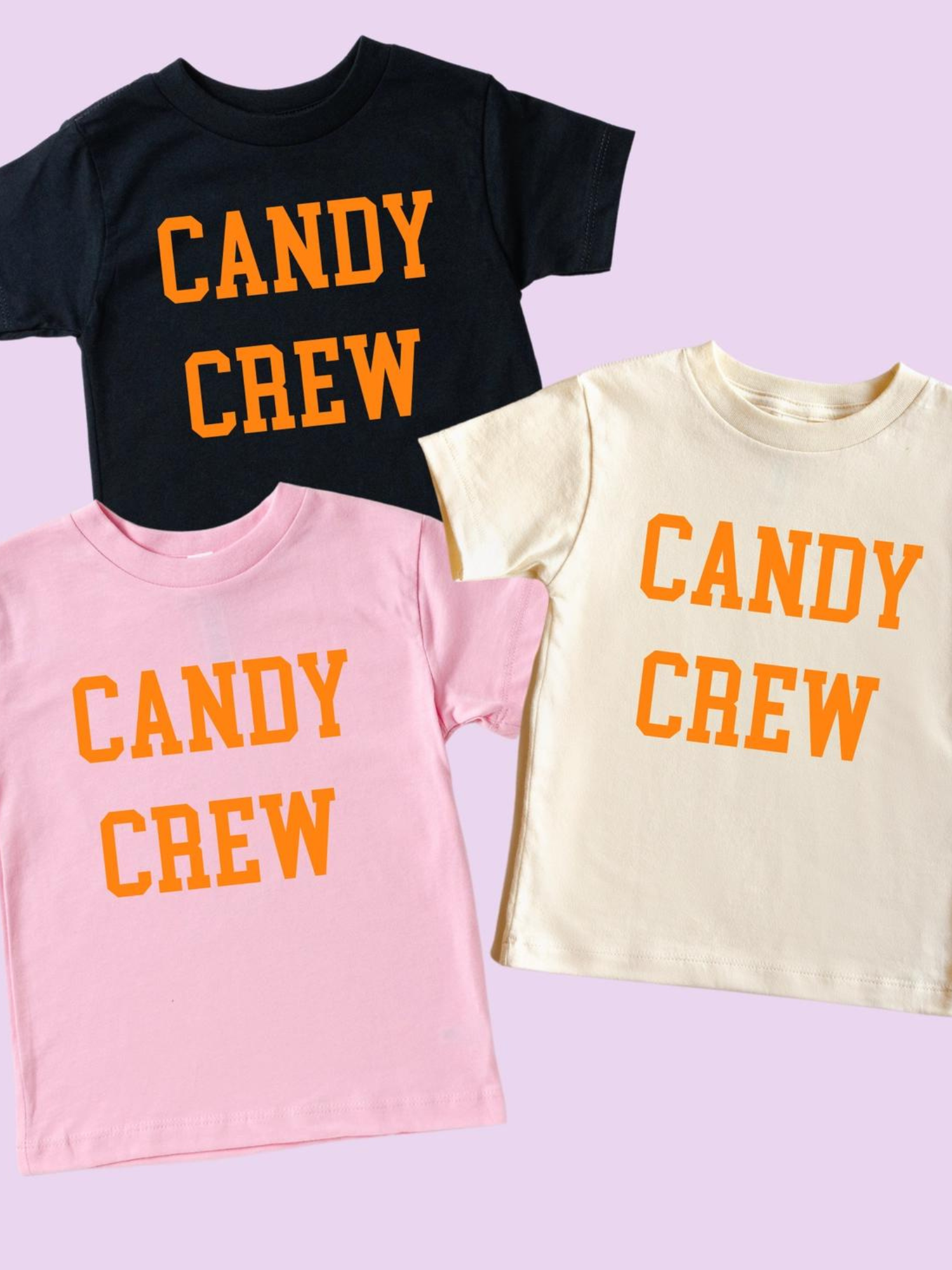 Three T-shirts in pink, cream, and black, all with "CANDY CREW" printed in orange on the front.