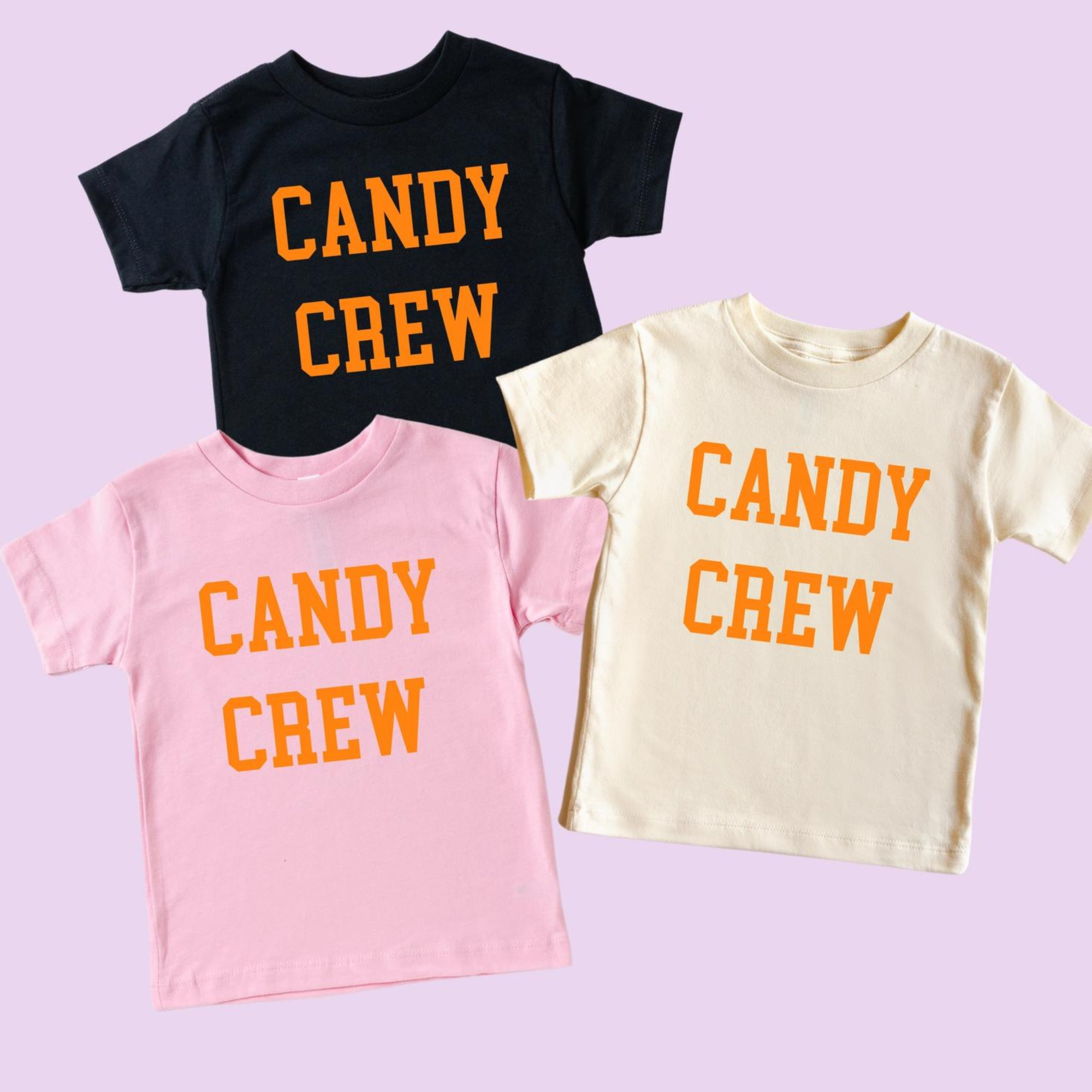 Three T-shirts in pink, cream, and black, all with "CANDY CREW" printed in orange on the front.