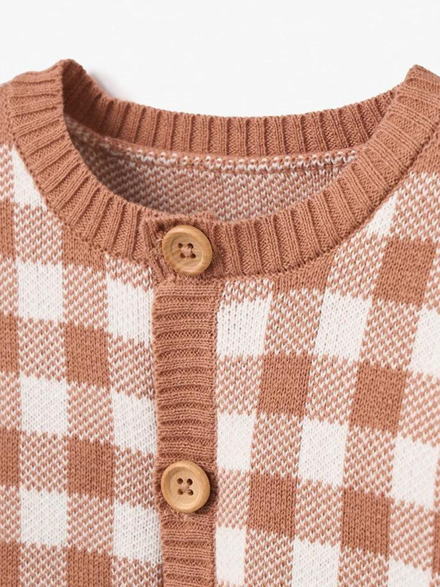 Light brown and white checkered cardigan with wooden buttons and a round neckline.