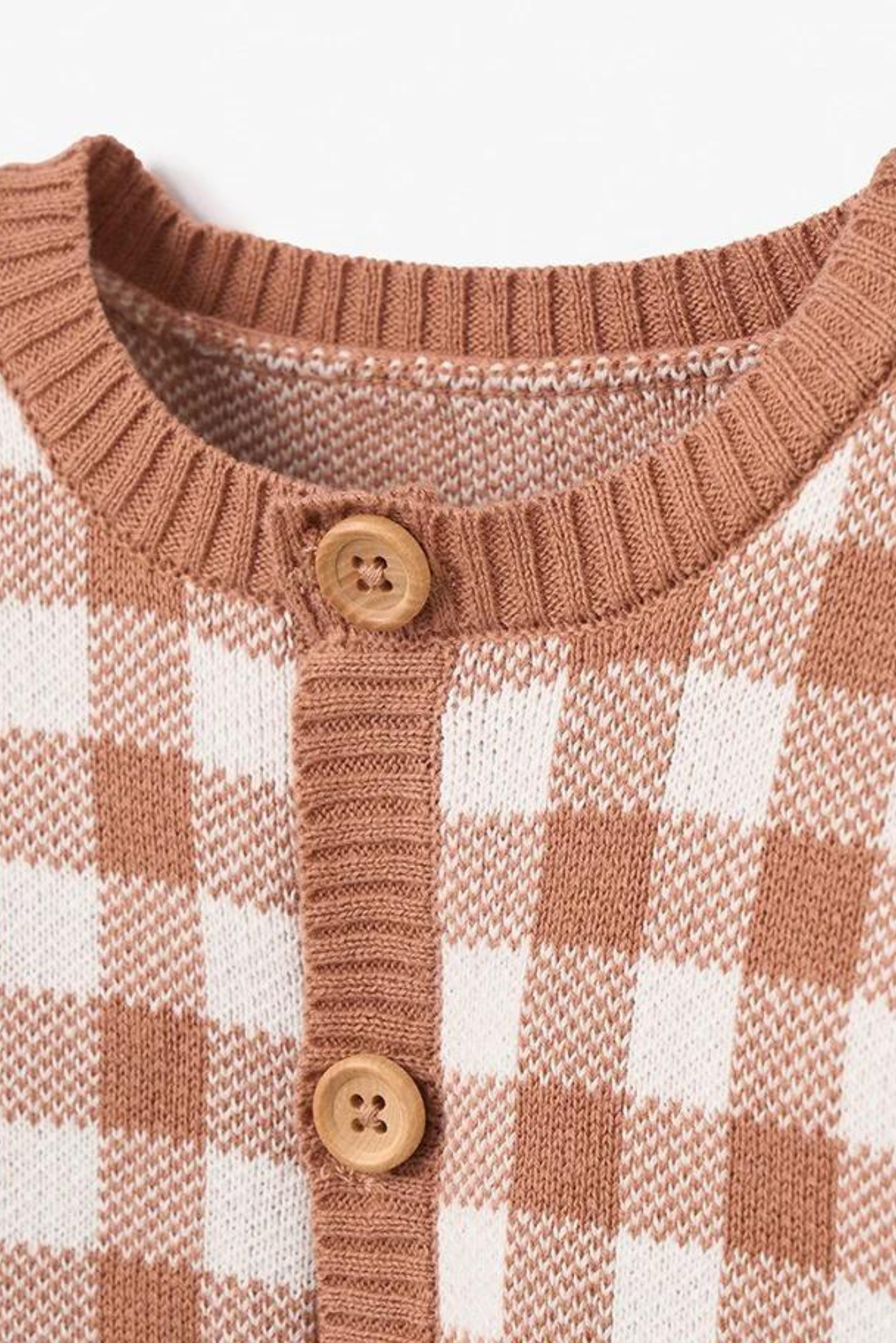 Light brown and white checkered cardigan with wooden buttons and a round neckline.