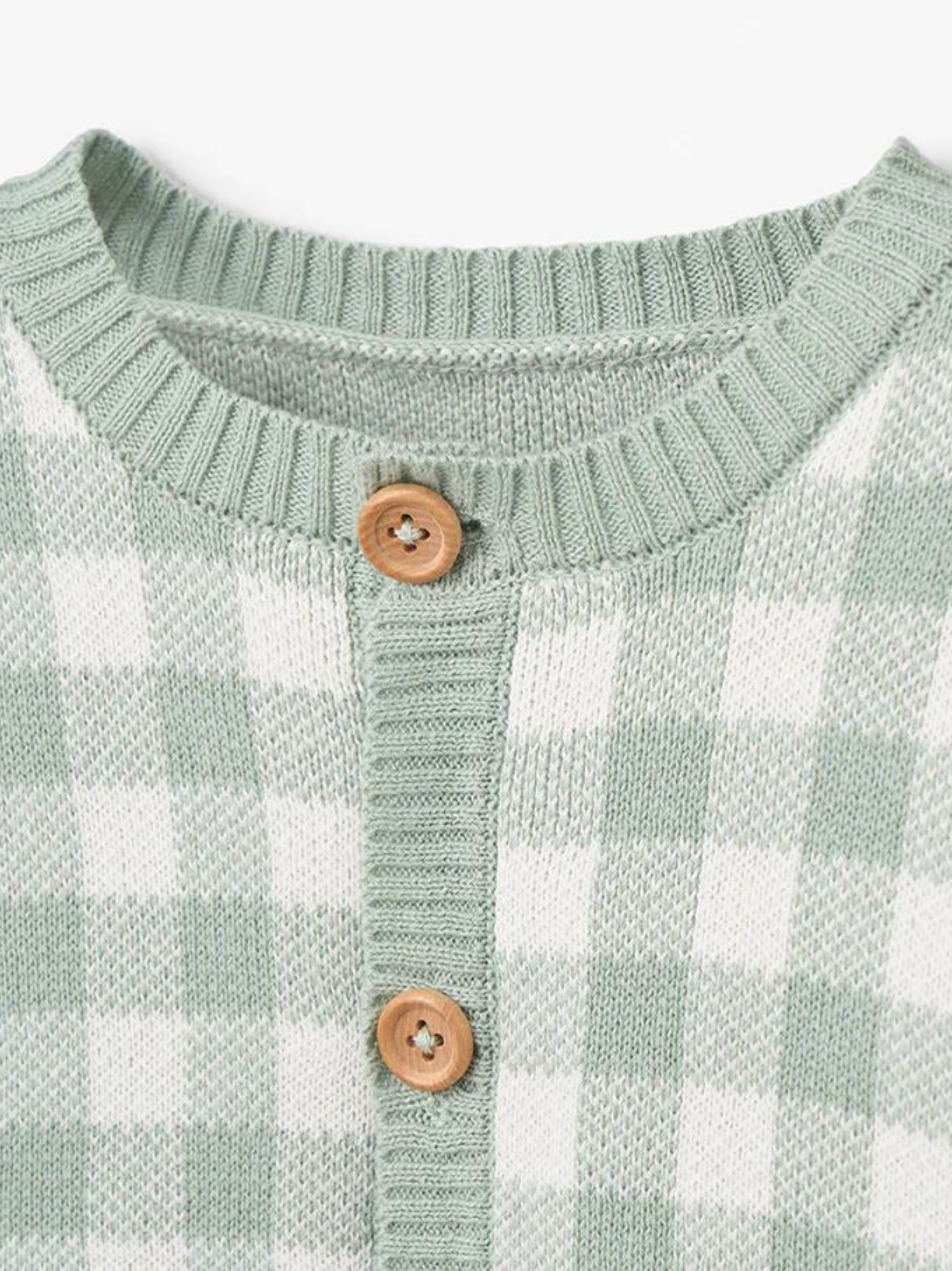 Green and white checkered sweater with a round neckline and wooden buttons.