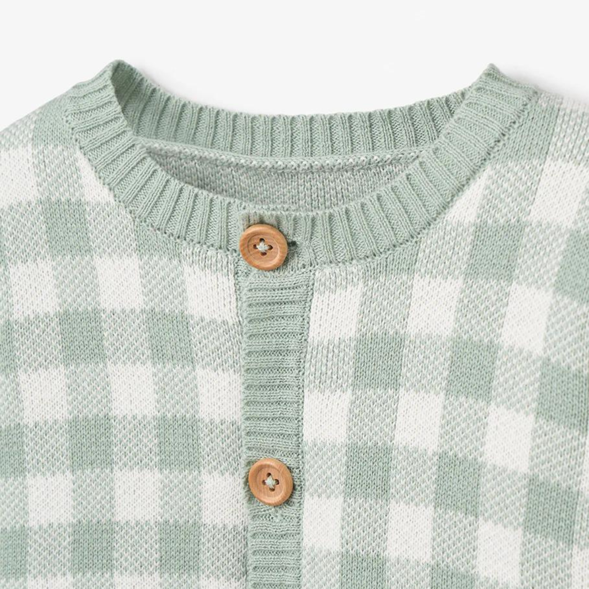 Green and white checkered sweater with a round neckline and wooden buttons.