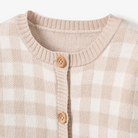 Beige and white checkered cardigan with wooden buttons and ribbed collar detail.
