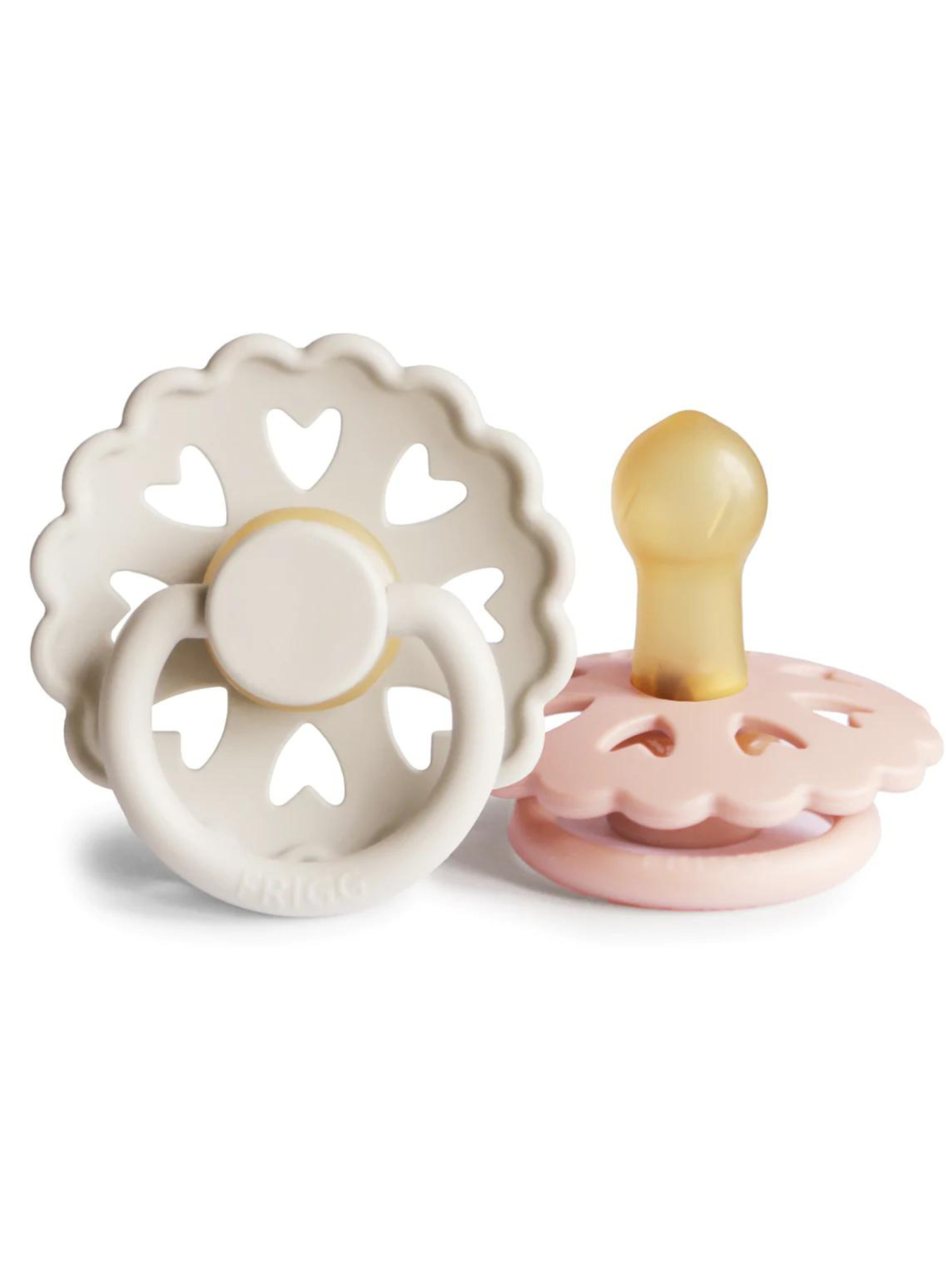 Two silicone pacifiers with floral designs, one in white and one in pink, featuring heart-shaped cutouts.