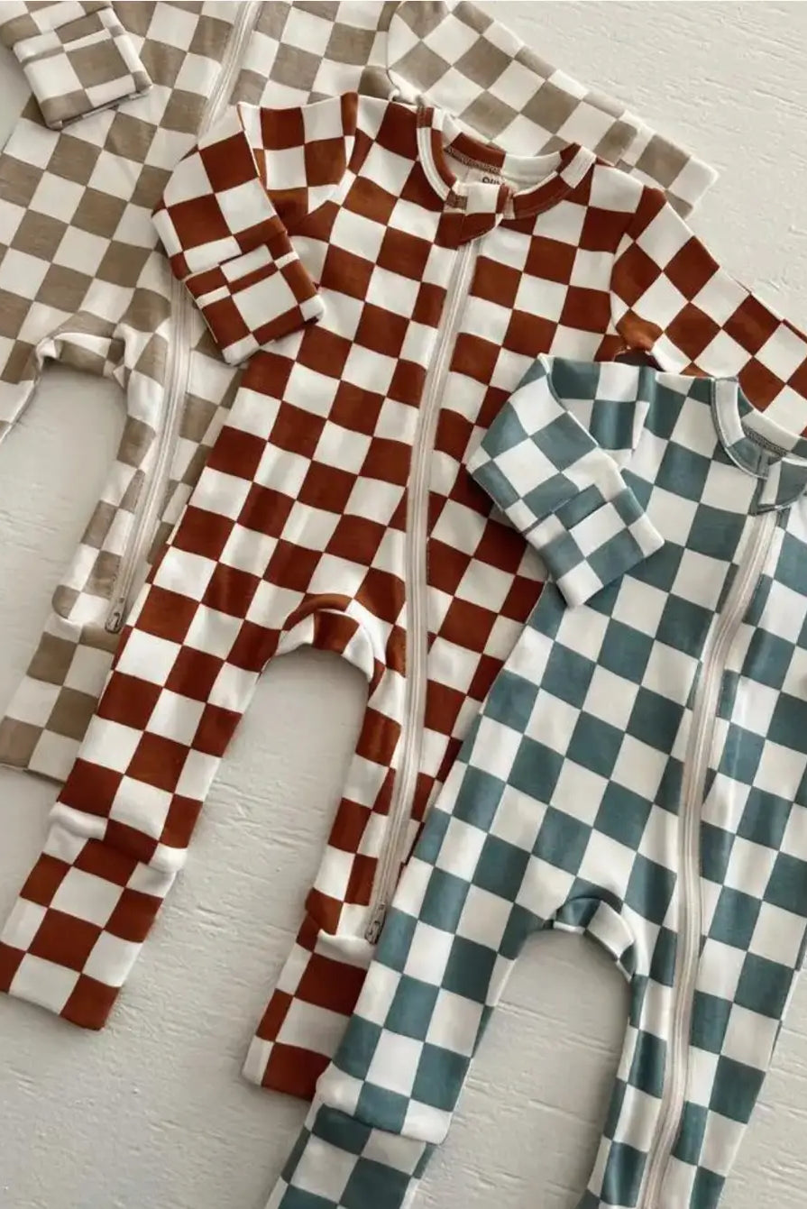 Three checkered zip-up baby onesies in tan, brown, and teal laid on a white background.