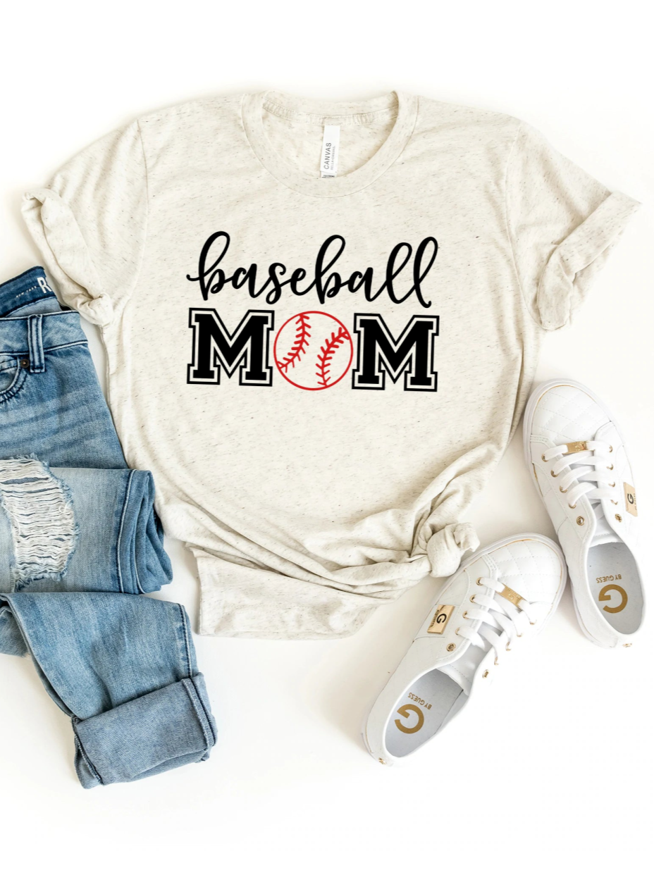 Baseball mom graphic t-shirt styled with jeans and white shoes on a light background.