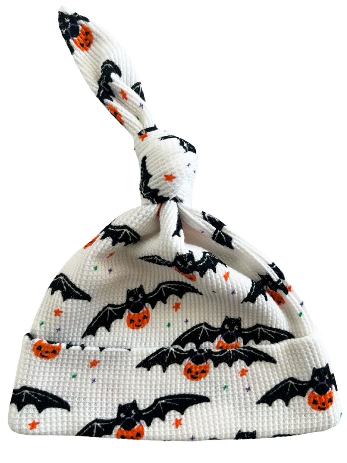 White baby hat with black bats and orange pumpkins, featuring a knotted top for a playful Halloween style.