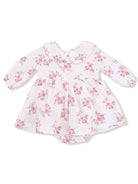 White dress with pink floral pattern and a collar, designed for infants, featuring long sleeves and a gathered skirt.