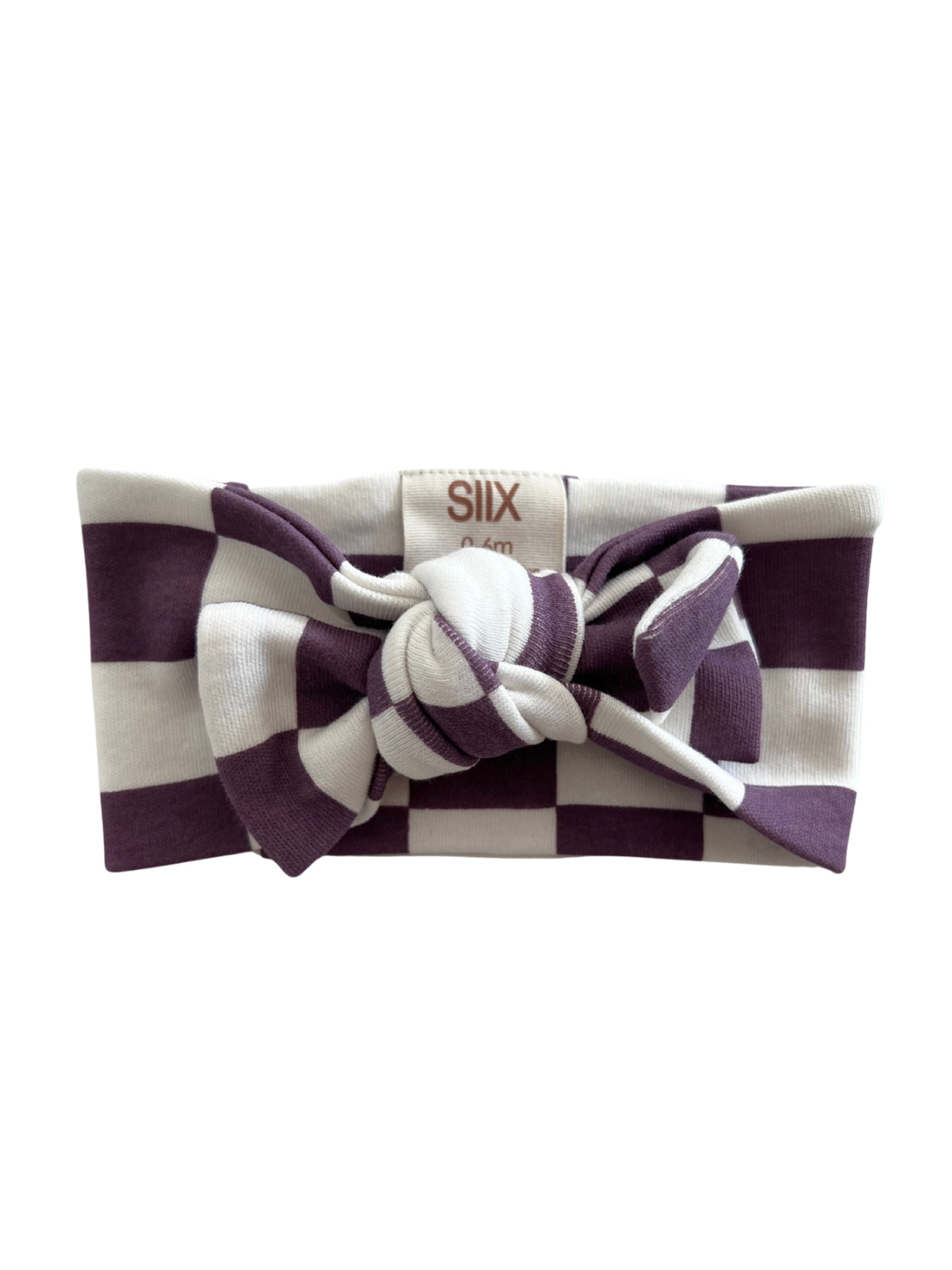 Purple and white striped headband with a bow, featuring a brand tag.