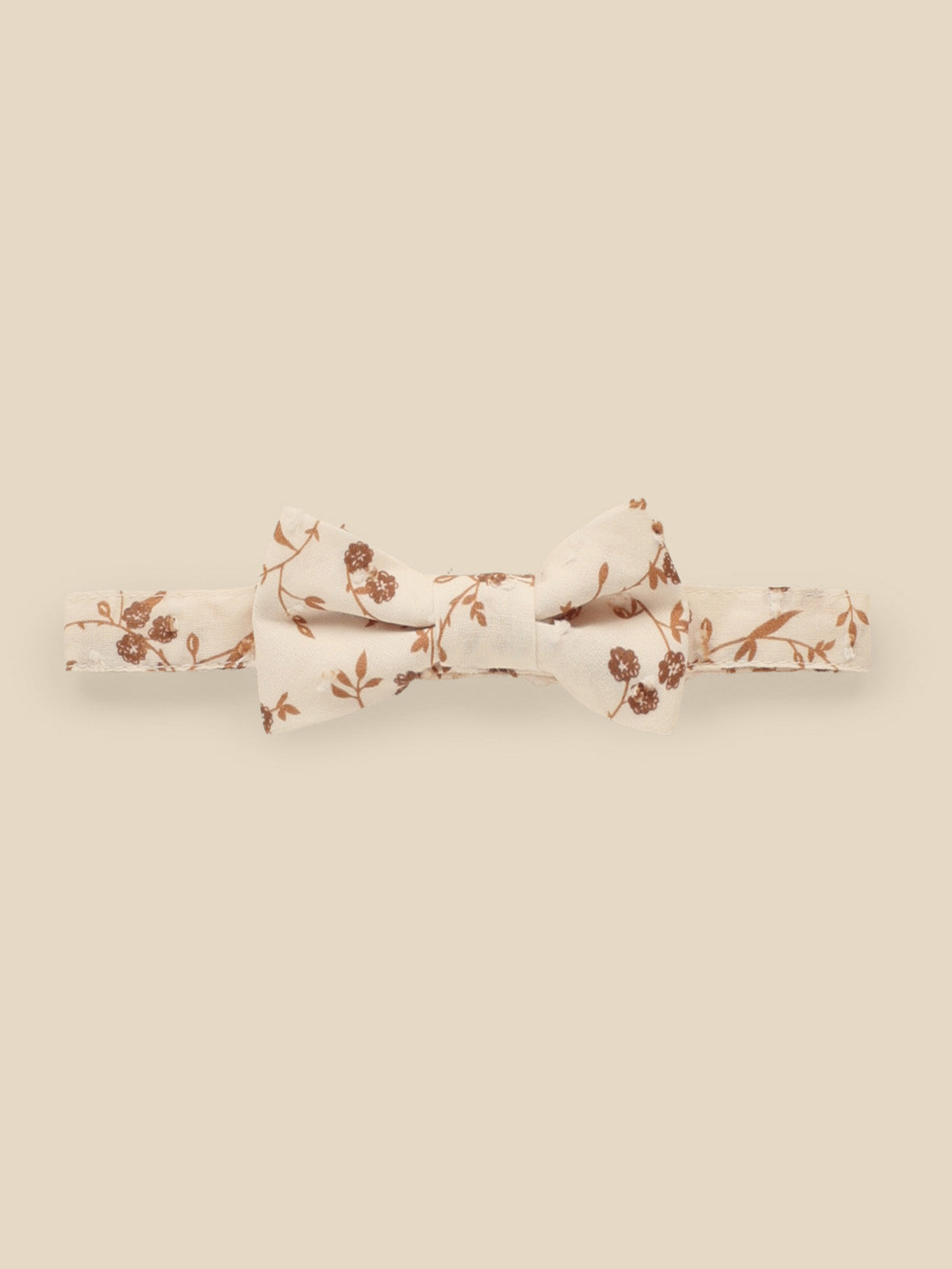 Floral bow tie in cream and brown on a light background. Perfect for formal or semi-formal occasions.
