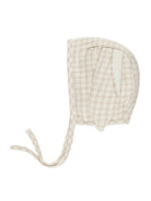 Beige plaid infant bonnet with ties, featuring a soft fabric and cute design. Ideal for baby outfits and photos.