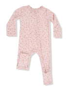 Pink long-sleeve onesie with a floral pattern and front zipper, featuring polka dot accents on the cuffs.