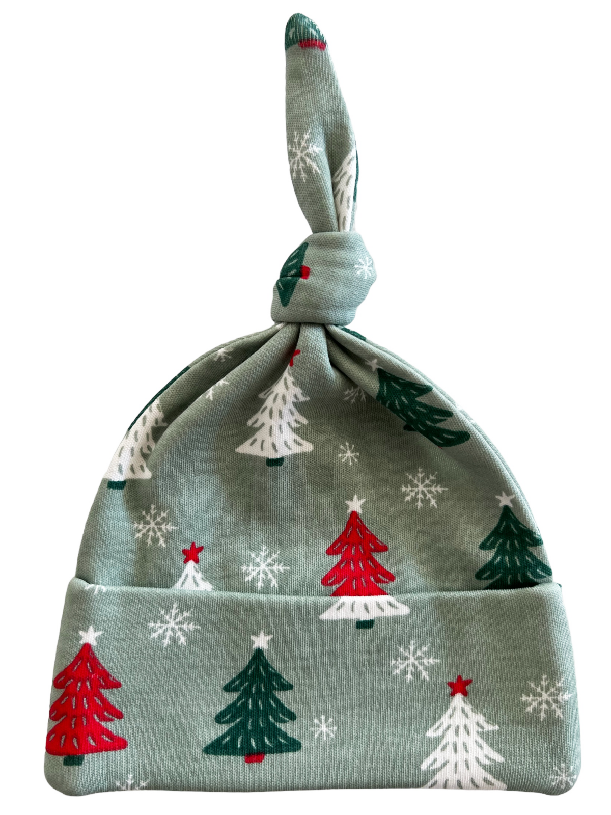 Green holiday baby hat with red and white Christmas trees and snowflakes, featuring a knotted top.