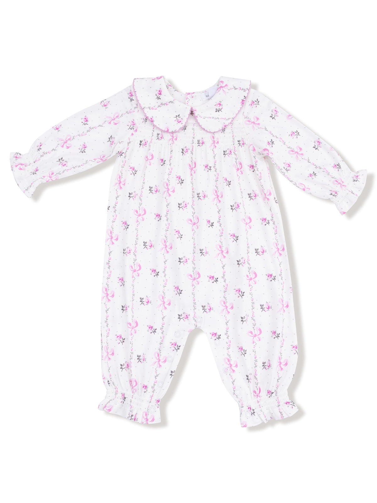 White baby romper with pink floral pattern and ruffled collar, long sleeves, and elastic cuffs.