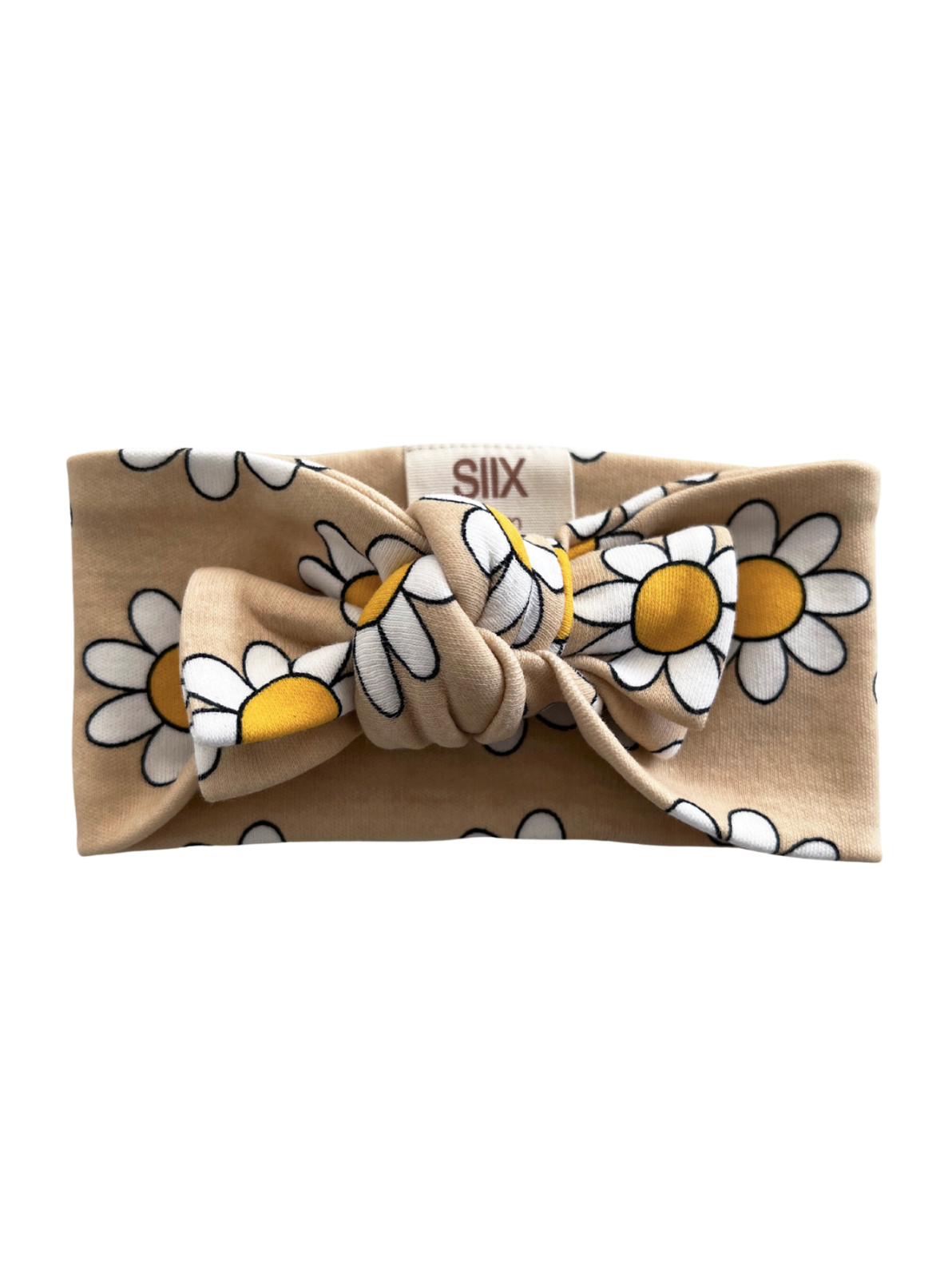 Beige headband with a large bow and white daisies with yellow centers. Text label visible.
