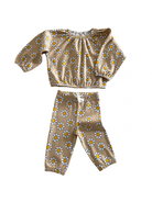 Brown floral children's outfit featuring a long-sleeve top and matching pants with yellow and white daisies.