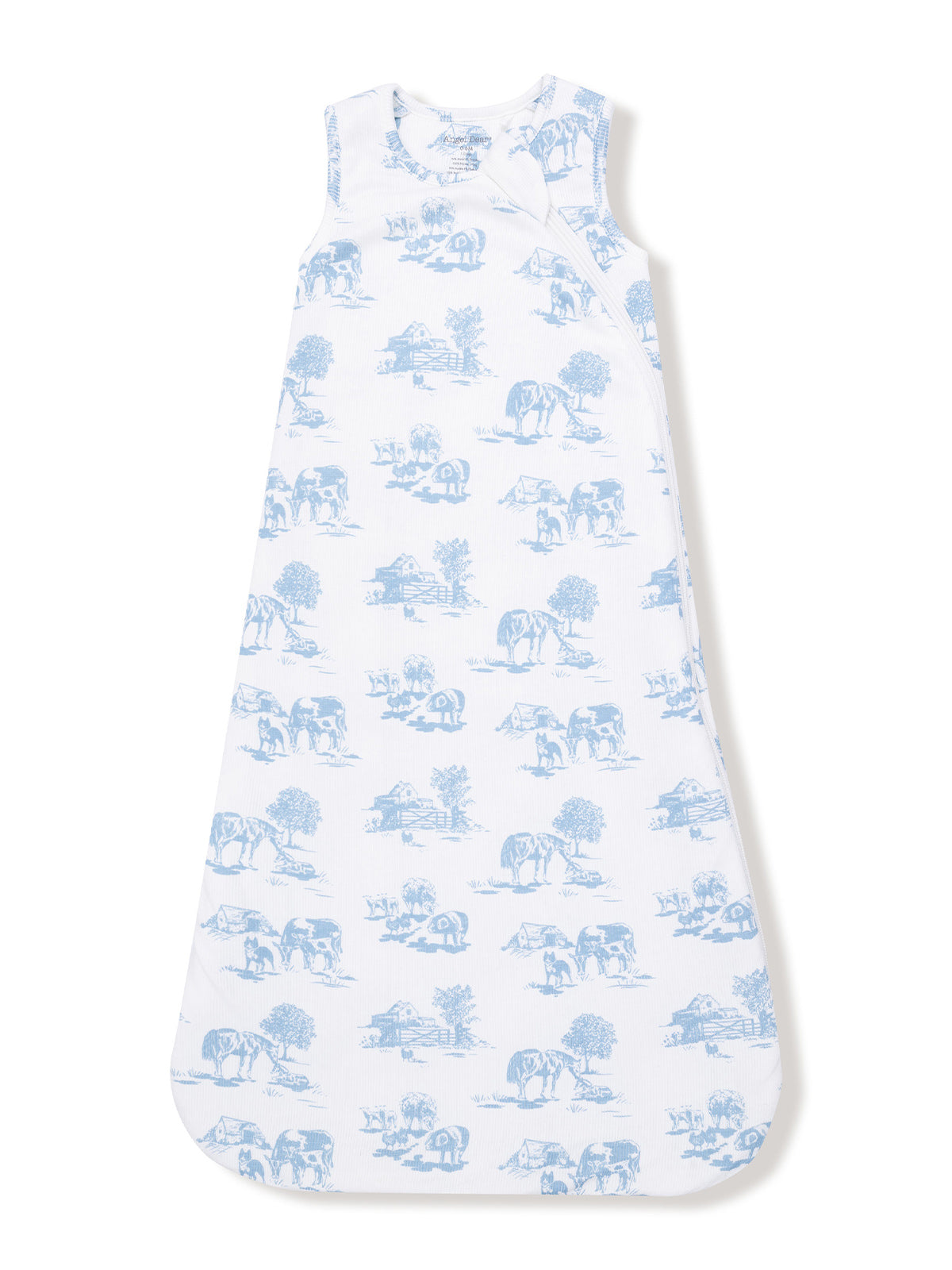 Toddler sleeping bag with blue farm animal print on white fabric, featuring cows, trees, and barns.