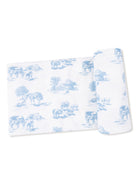 Blue and white patterned fabric featuring farm scenes with cows and trees.