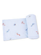 Light blue fabric with embroidered squid designs, folded and rolled for display. Perfect for cozy decor.