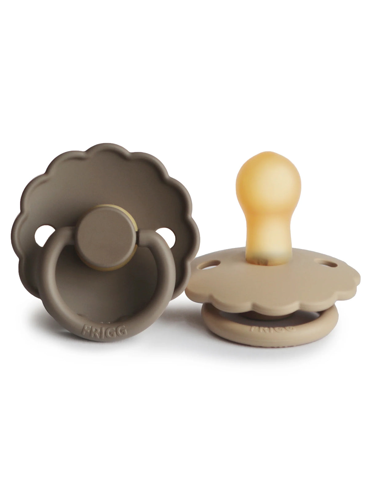 Two stylish silicone pacifiers in neutral colors, featuring scalloped designs and a round handle for easy grip.