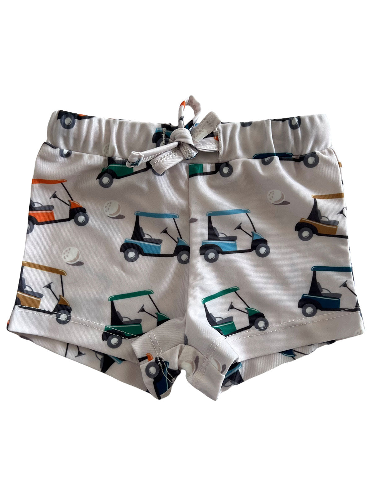 Kid's swim shorts featuring a playful golf cart pattern on a light background.